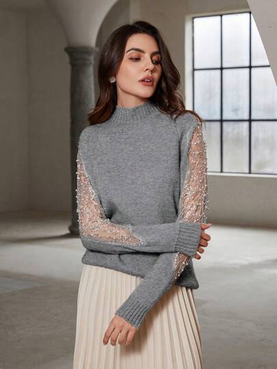 Moderner figurbetonter Pullover mit einzigartigen Perlenakzenten von Aphrodite™.
